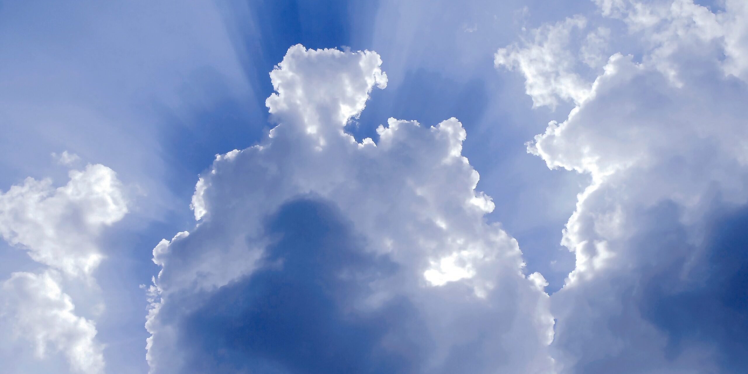 blue-sky-white-clouds-light-beams